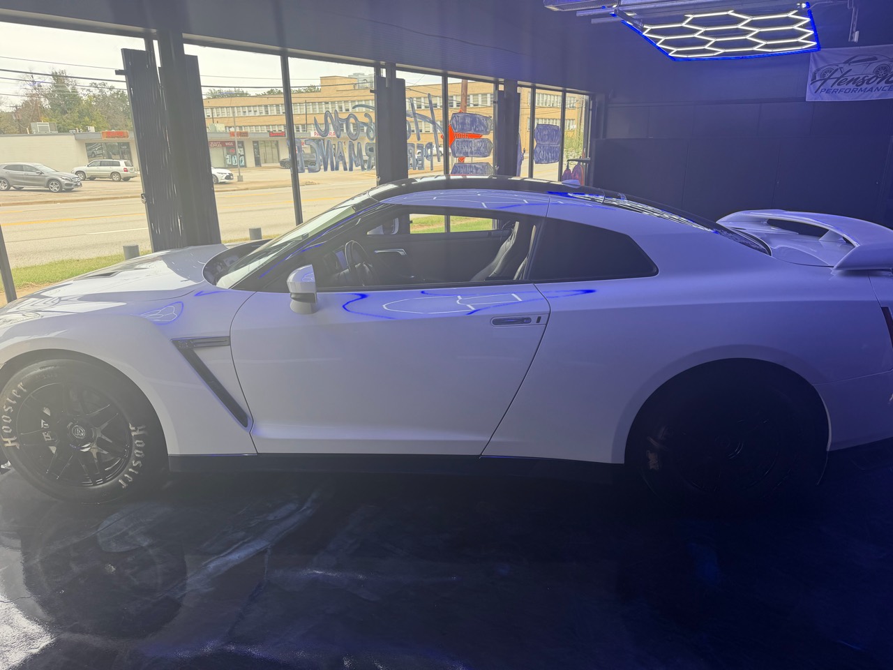 Side profile of the white Nissan GT-R with black wheels at Henson Performance